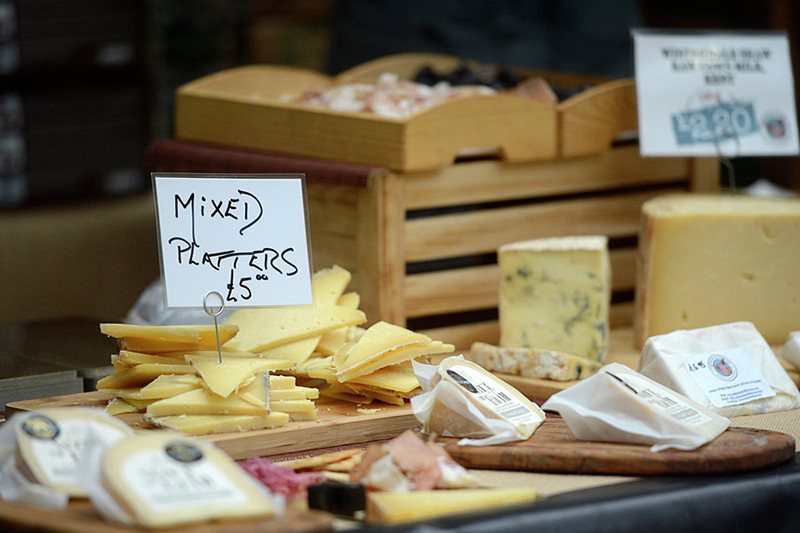 A trade stand of cheeses