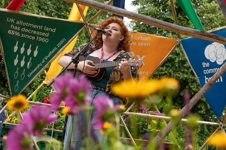 Musician Willow performs amongst the allotments at RHS Hampton 2021